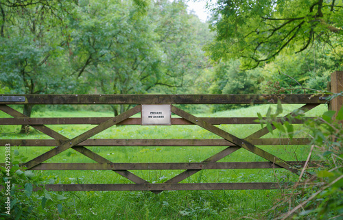 5-bar wooden gate to orchard and meadows with a Private, No Access sign 