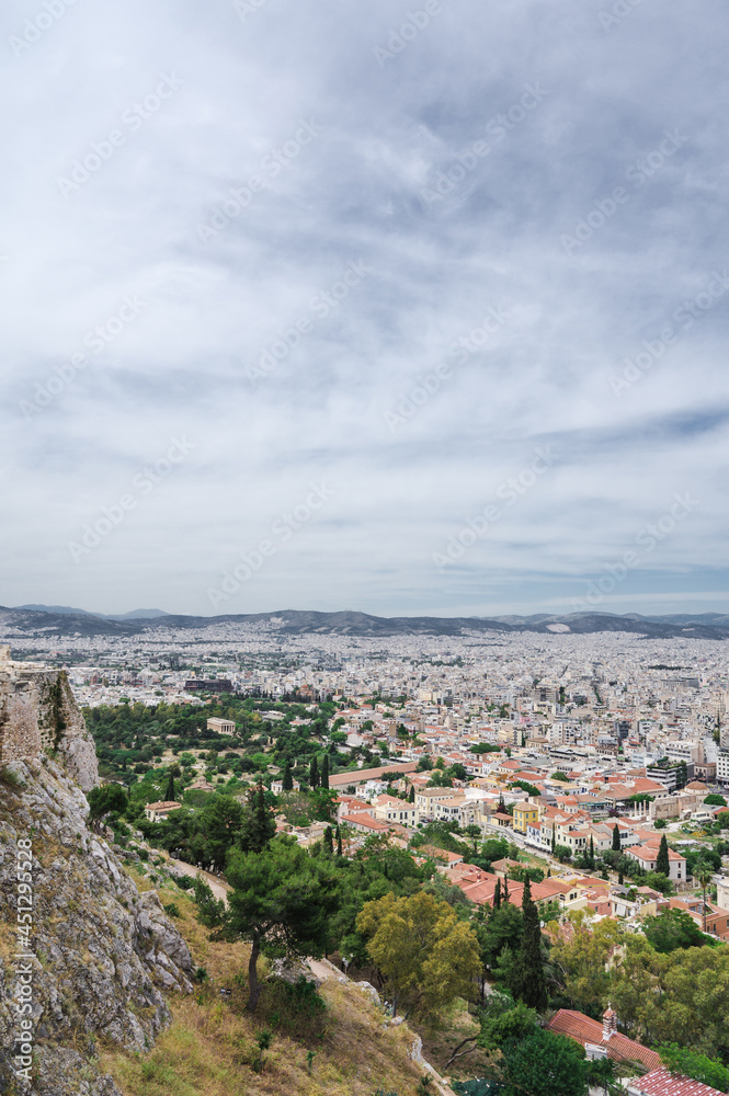 Cityscape of Athens at cloudy day. City near mountain. Urban architecture in Europe. View from Acropolis hill.