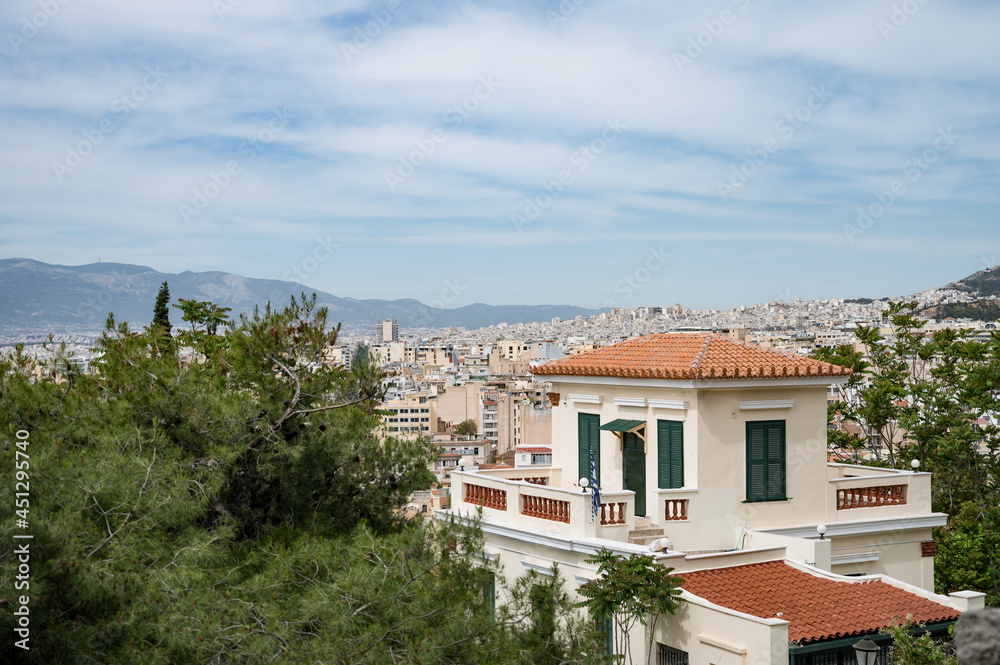 Cityscape of Athens at cloudy day. City near mountain. Urban architecture in Europe. View from top.