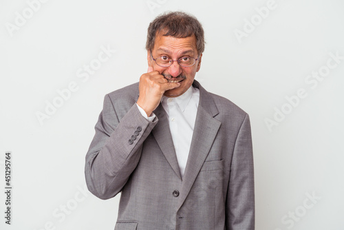 Middle aged indian business man isolated on white background biting fingernails, nervous and very anxious.