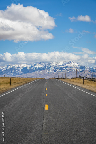 A long, straight road heading into the distant mountains in Idaho.