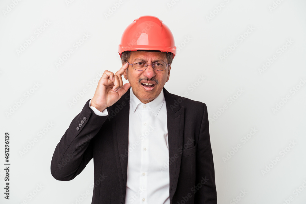 Middle aged indian architect man isolated on white background showing a disappointment gesture with forefinger. Middle aged indian architect man isolated on white background showing a disappointment gesture with forefinger.