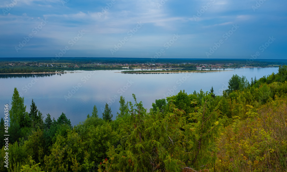 Kokshaysk, Russia - August, 09 2021: Panoramic view of the village of Kokshaisk and mouth of the Bolshaya Kokshaga River from the opposite high shore of the Volga River