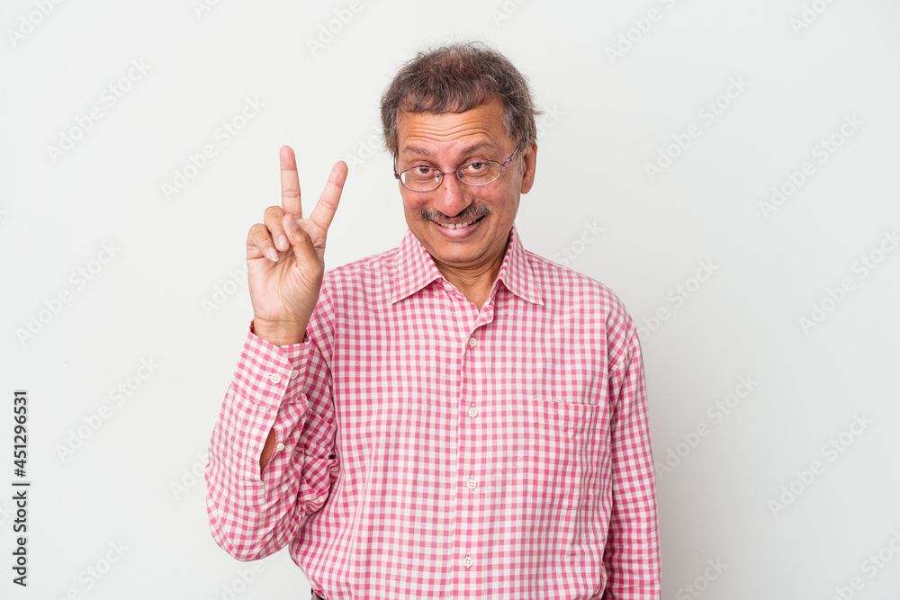 Middle aged indian man isolated on white background showing victory sign and smiling broadly. Middle aged indian man isolated on white background showing victory sign and smiling broadly.