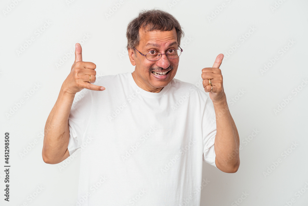 Middle aged indian man isolated on white background showing a mobile phone call gesture with fingers. Middle aged indian man isolated on white background showing a mobile phone call gesture with fingers.