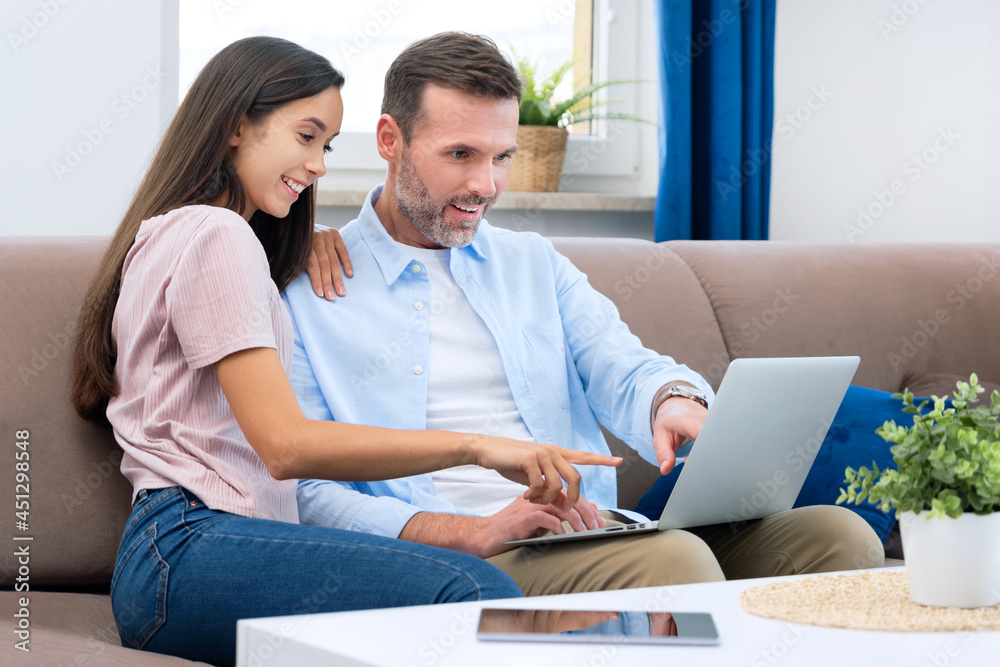 Couple using laptop, watching movie, browsing web Couple using laptop, watching movie, browsing web