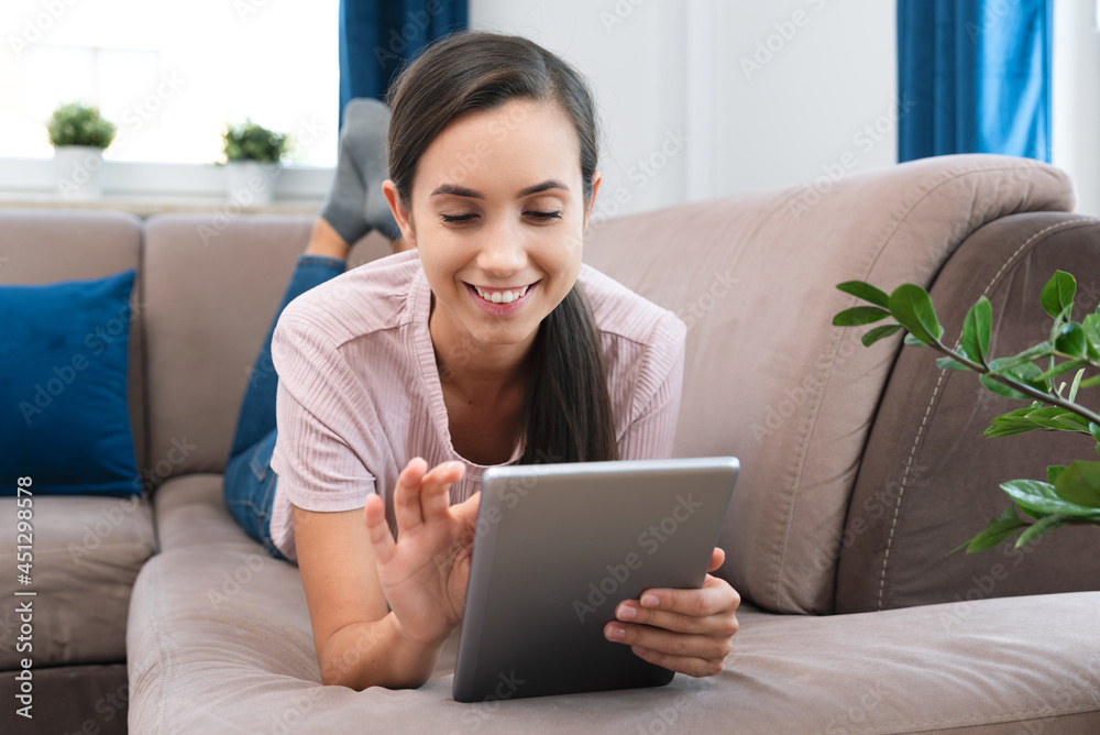 Woman using tablet or e-book, surfing internet Woman using tablet or e-book, surfing internet