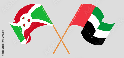 Crossed and waving flags of Burundi and the United Arab Emirates
