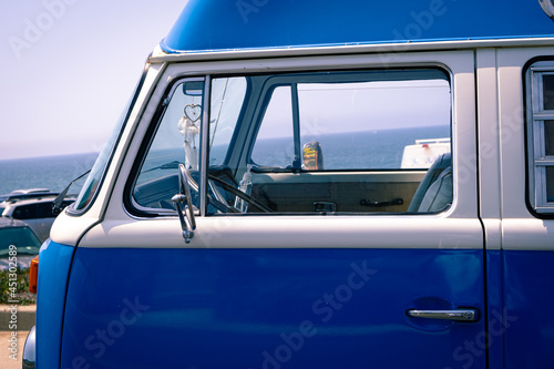 Blue Mini Van Parked Next to the Beach