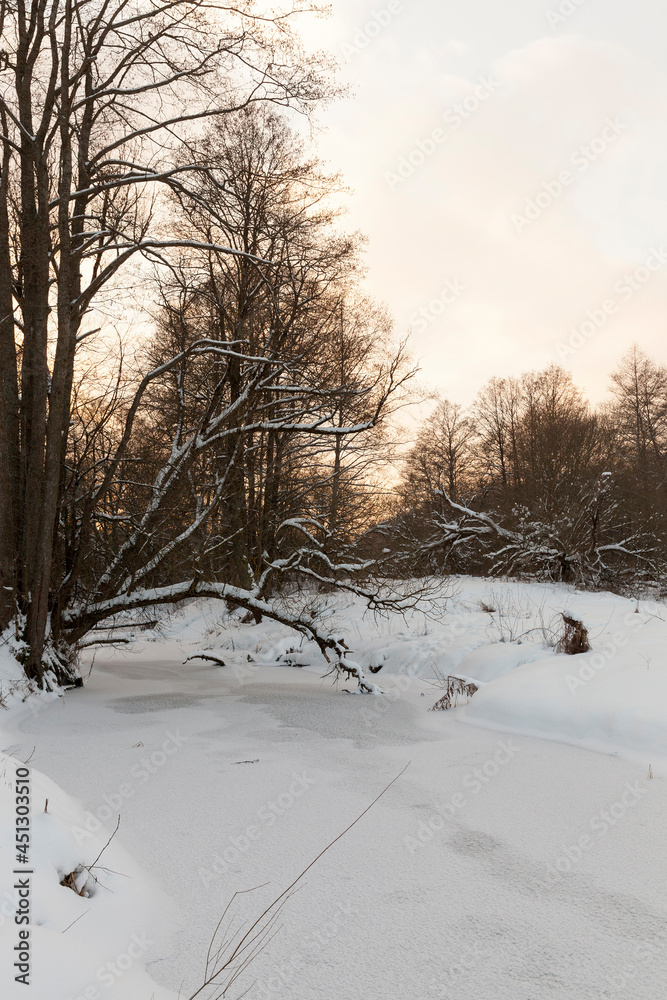 Fototapeta premium snow-covered river at sunset