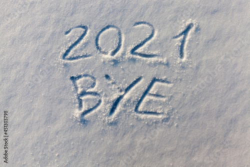 the inscription about the new year 2022 on the snow in winter