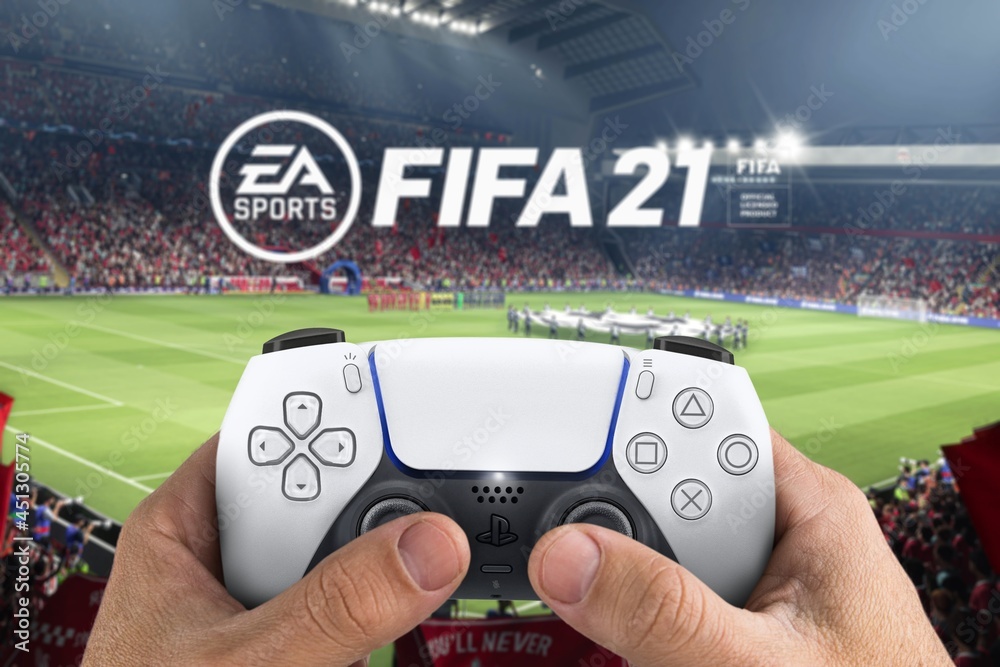 Male hand holding a Playstation 5 Dual Sense Controller with FIFA 21 game  blurred in the background. Rio de Janeiro, RJ, Brazil. July 2021. Stock  Photo | Adobe Stock