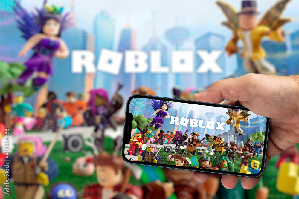 Roblox Logo and App on a Mobile Screen in a Hand Editorial Stock