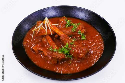 indian food, slow cooked indian lamb or mutton shank curry, also known as nalli rogan josh