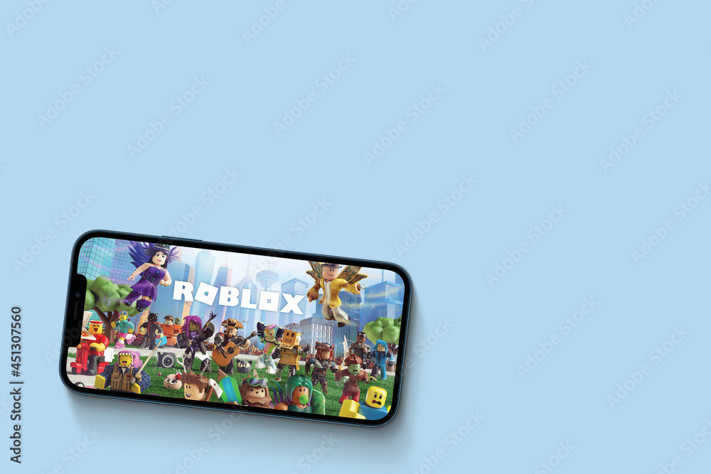 Roblox game app on the smartphone screen on blue background. Top view. Rio  de Janeiro, RJ, Brazil. June 2021. Stock Photo