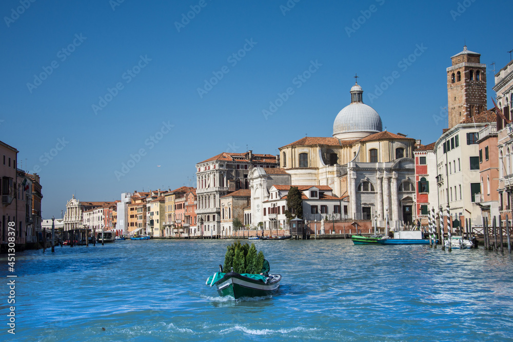 the boat carries a fir tree on the Grand Canal, Venice, Italy, 2019. march