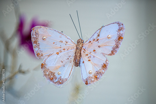 Artificial gold and white butterfly  with gems and stones photo