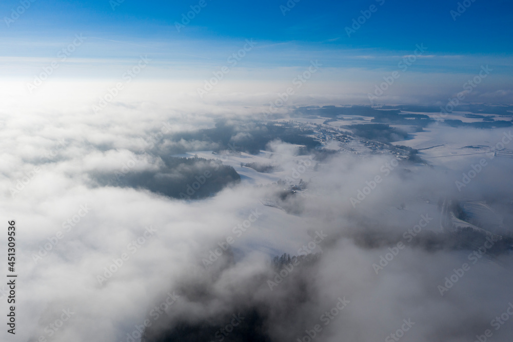 An amazing aerial shot of a winter landscape above the clouds. An amazing aerial shot of a winter landscape above the clouds.