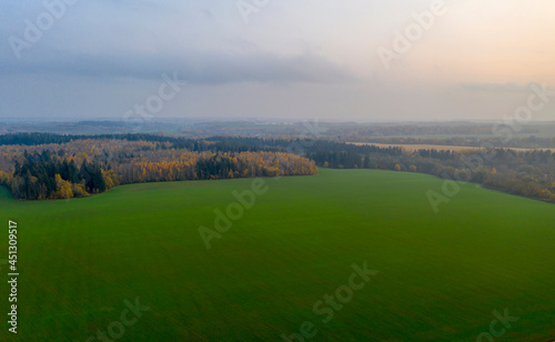 Aerial view of agricultural landscape in autumn season on sunset.