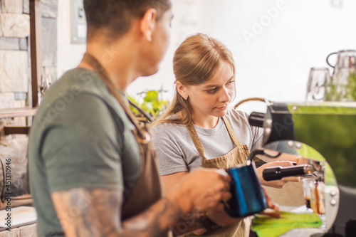 Caucasian woman barista making coffee