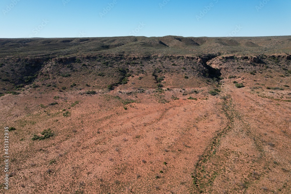 Outback Australia aerial drone photo over the wild rugged limestone mountain ranges and dry desert landscape of Cape Range National Park, Ningaloo Coast