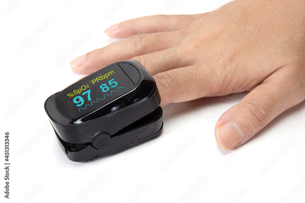 Pulse oximeter on the index finger isolated on a white background. Pulse oximeter on the index finger isolated on a white background.