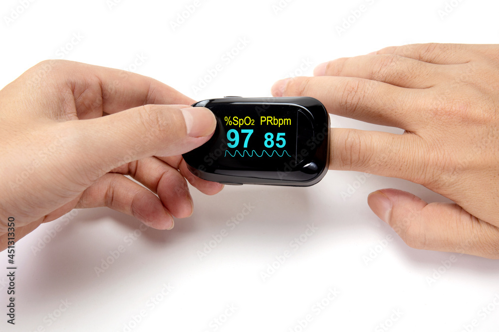 Pulse oximeter on the index finger isolated on a white background. Pulse oximeter on the index finger isolated on a white background.