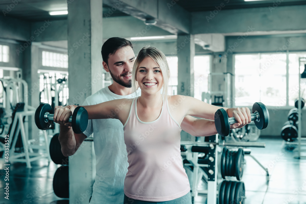 Couple Love Exercising Workout in Fitness Training Room, Young Couple Caucasian Working Out and Exercise Training Together With Dumbbell Equipment in Fitness Club. Fitness Sport Trainer Lifestyles Couple Love Exercising Workout in Fitness Training Room, Young Couple Caucasian Working Out and Exercise Training Together With Dumbbell Equipment in Fitness Club. Fitness Sport Trainer Lifestyles
