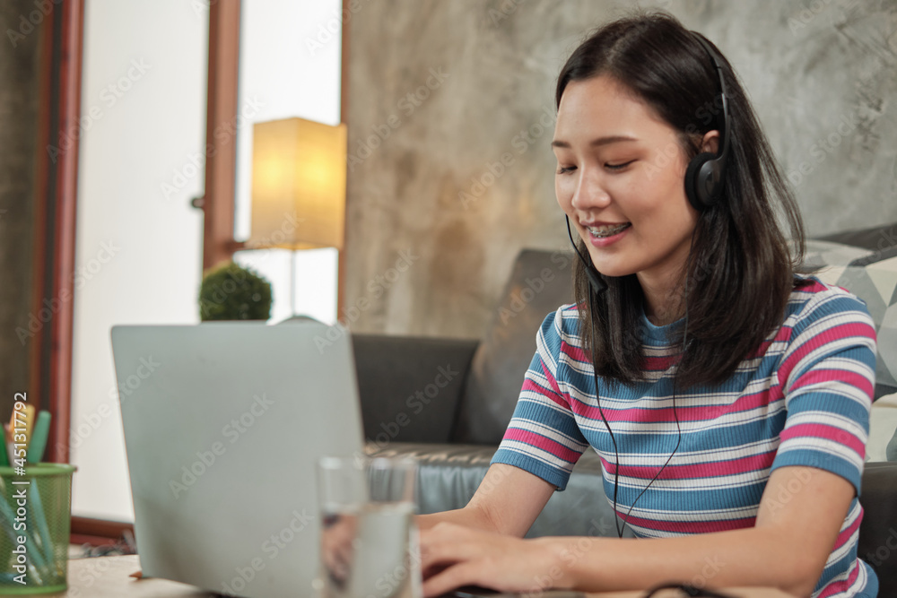 Freelance casual Asian woman typing on laptop for online shopping, e-commerce chat, business communications, and internet learning while working from home. Quarantine due to COVID-19 lifestyle. Freelance casual Asian woman typing on laptop for online shopping, e-commerce chat, business communications, and internet learning while working from home. Quarantine due to COVID-19 lifestyle.