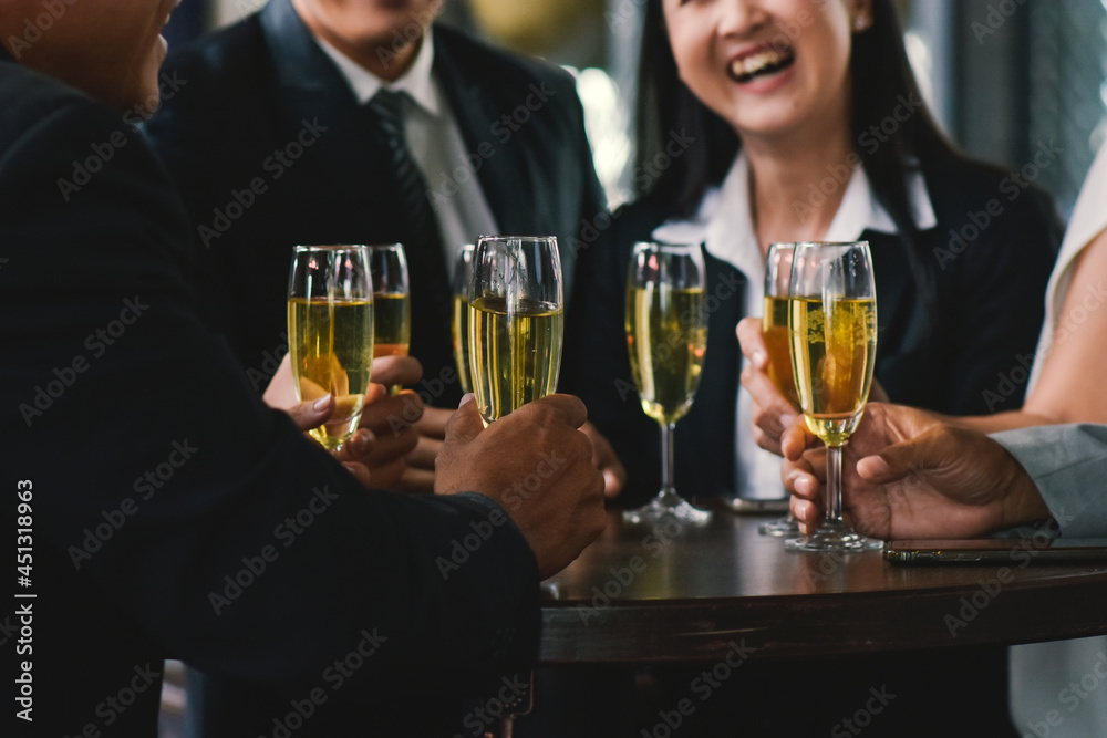 Closeup hand holding glasses wine for drink to celebrate teamwork business success Closeup hand holding glasses wine for drink to celebrate teamwork business success