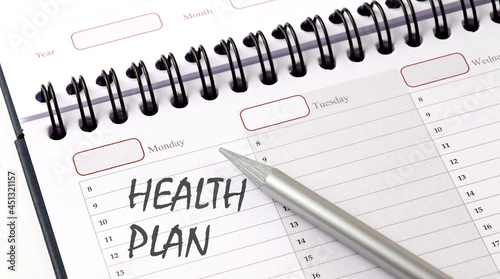 HEALTH PLAN on the planner with pencil, medicina