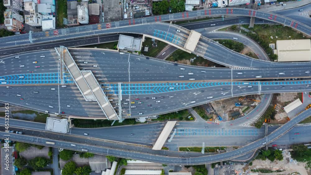 Time lapse of aerial view of busy cars with traffic jam in the rush hour on highway road street on bridge in Bangkok Downtown, urban city, Thailand at night. Intersection junction. Toll gate in Rama 9 Time lapse of aerial view of busy cars with traffic jam in the rush hour on highway road street on bridge in Bangkok Downtown, urban city, Thailand at night. Intersection junction. Toll gate in Rama 9