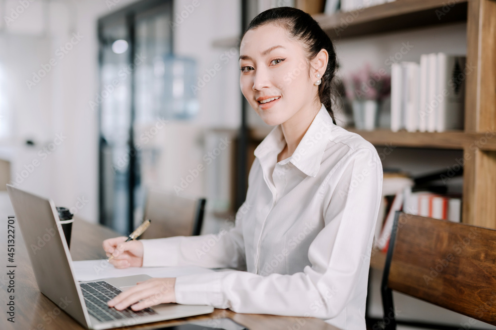 Concentrated young beautiful businesswoman working on laptop in bright modern office,Work from home concept Concentrated young beautiful businesswoman working on laptop in bright modern office,Work from home concept