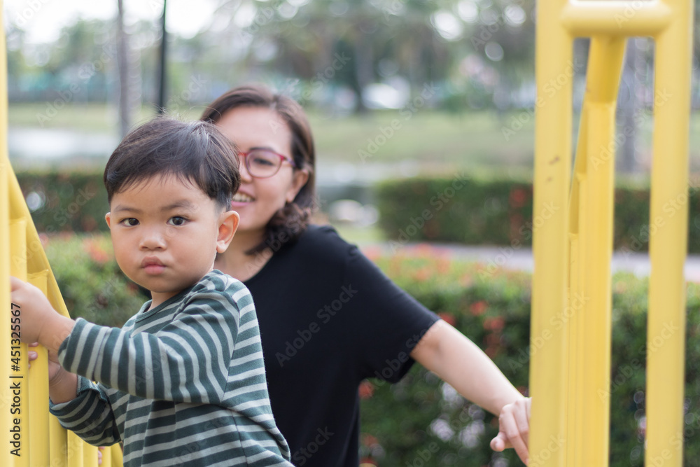 Fototapeta premium Son and mother on the playground.