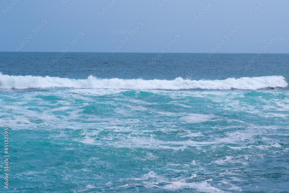 Beautiful strong blue waves in the sea.