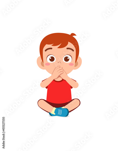 cute little boy covering mouth with hand pose