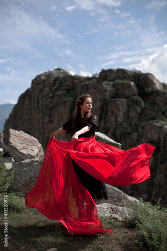 beautiful girl, brunette in a black dress with a red belt, photo session in the mountains, altai, red lips