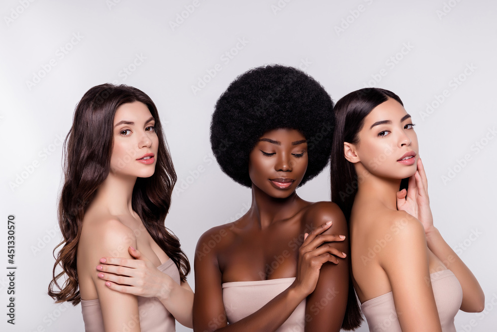 Photo of three young woman happy positive smile pampering hydration skincare isolated over grey color background Photo of three young woman happy positive smile pampering hydration skincare isolated over grey color background