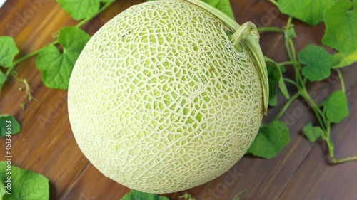 Top view Rotate Sweet Hokkaido melons on wooden table, Fresh Japanese Hokkaido melons very sweet and juicy.