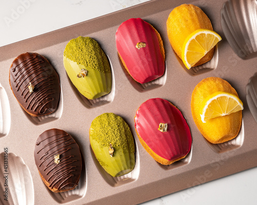 French traditional madeleine biscuits with 4 type of madeleines,Food concept background. photo