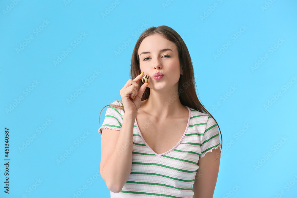 Beautiful young woman with chocolate candy on color background Beautiful young woman with chocolate candy on color background