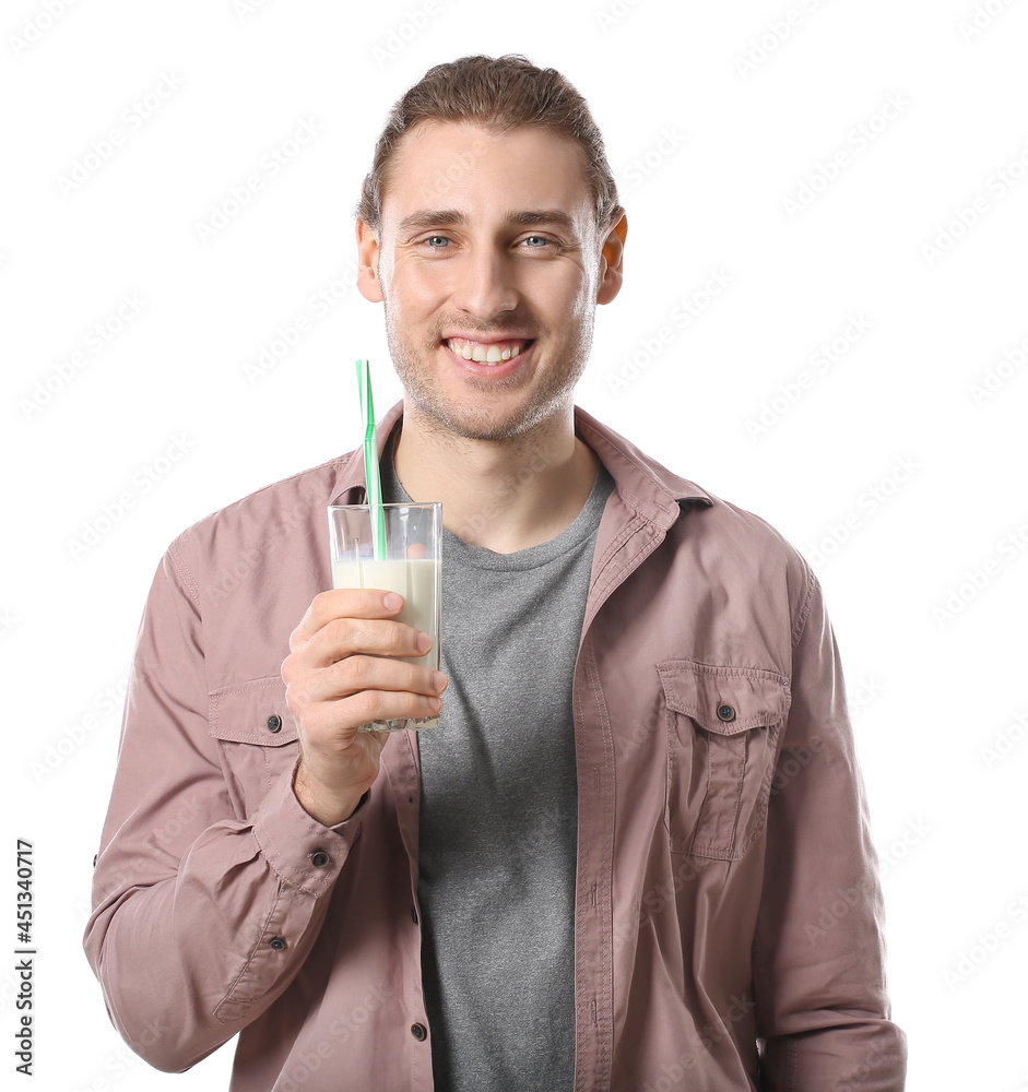 Young man with glass of milk on white background