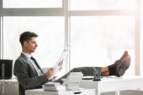Young businessman reading n...