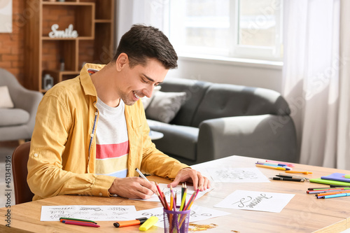 Photography Young male calligrapher working at home