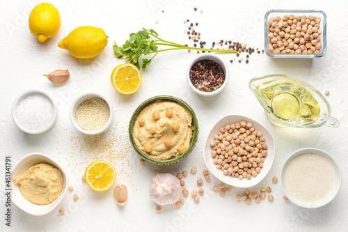 Composition with tasty hummus on light background