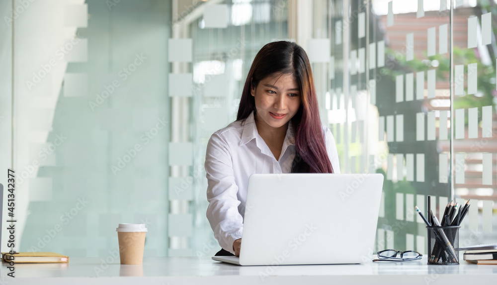 Portrait asian woman using laptop computer for online education at home Portrait asian woman using laptop computer for online education at home
