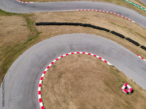 Curves on karting race track, aerial view background. © puckillustrations