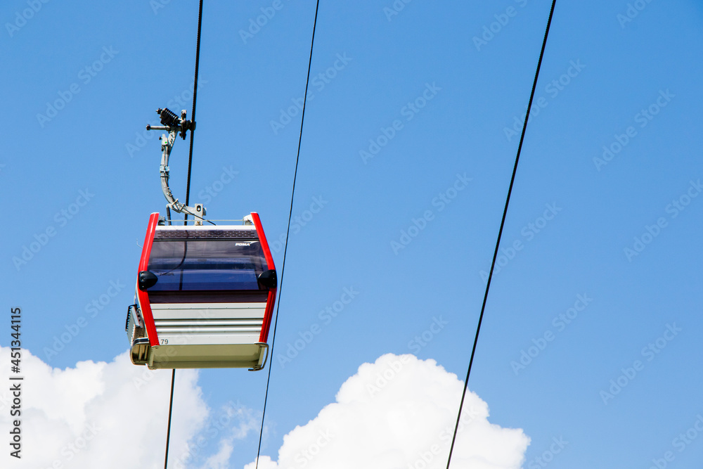 Air cabin and gondola lift transport on the sky background