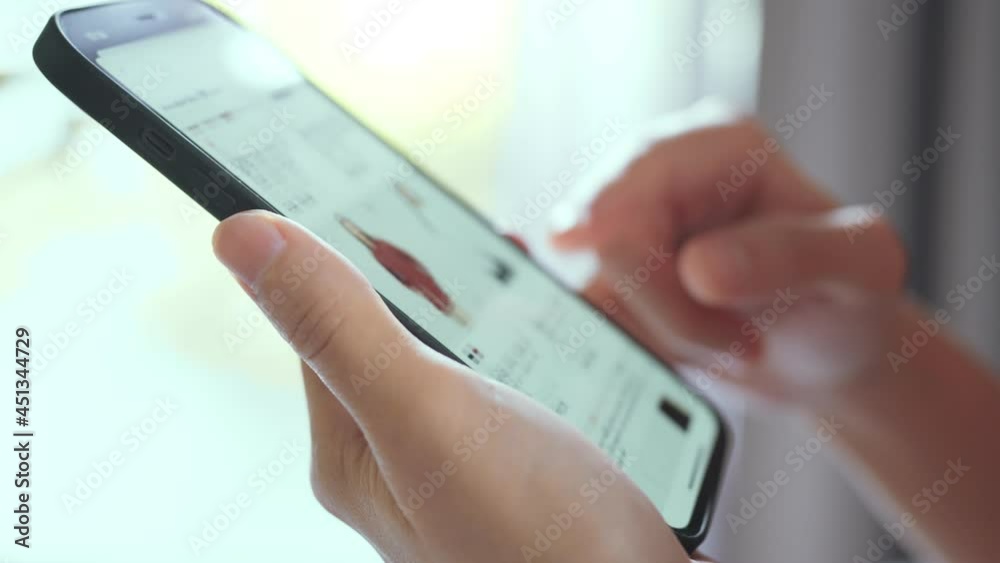 Woman online shopping on smart phone fashion clothes at home