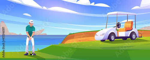 Golf course on lake shore with man and cart